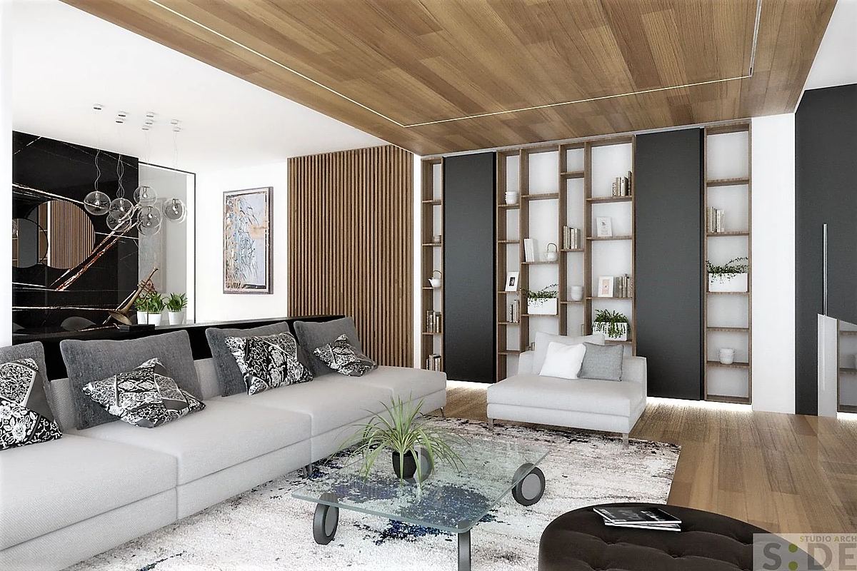 Living con soffitto in legno e libreria su misura